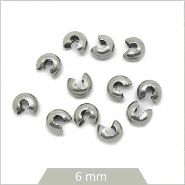 Env. 30 perles cache nœud en acier 6 mm