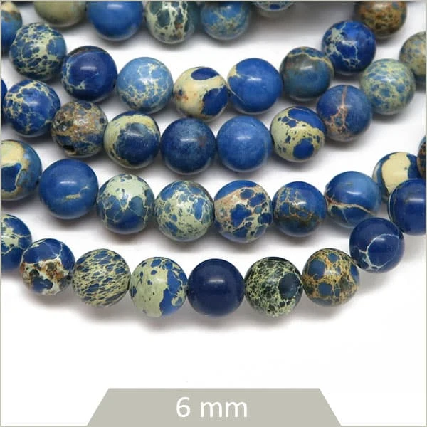 Env. 60 perles rondes Régalite teintée bleu 6 mm